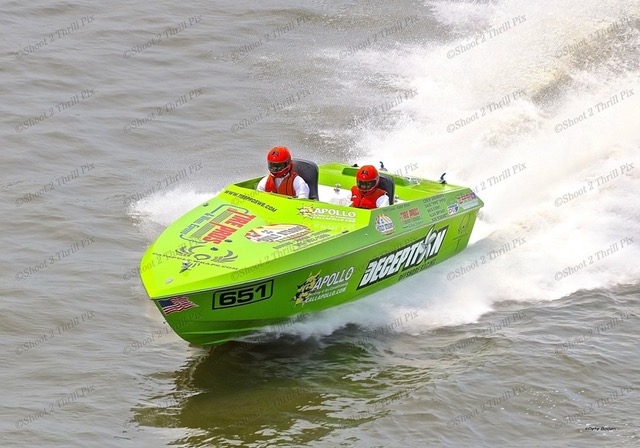A green speedboat racing across the water.